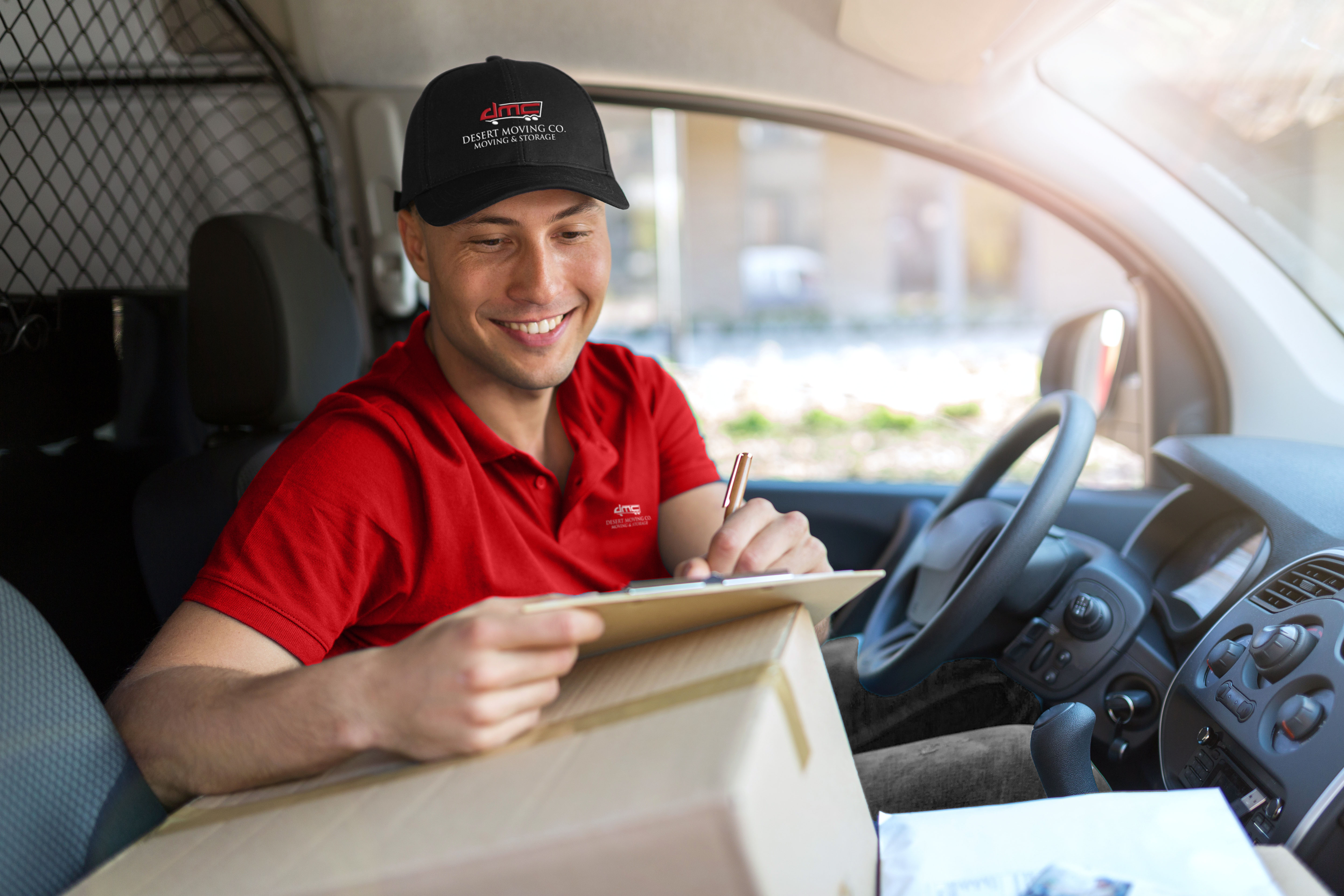Desert Moving mover reviewing paperwork in van