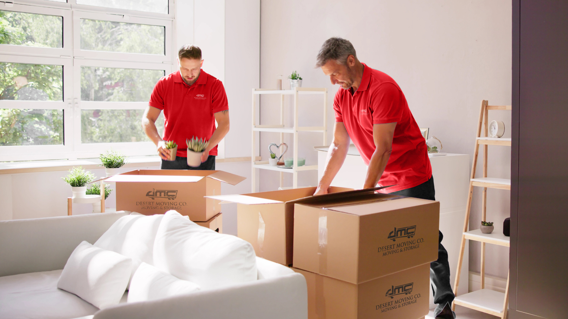 Desert Moving crew packing branded boxes in residential living room