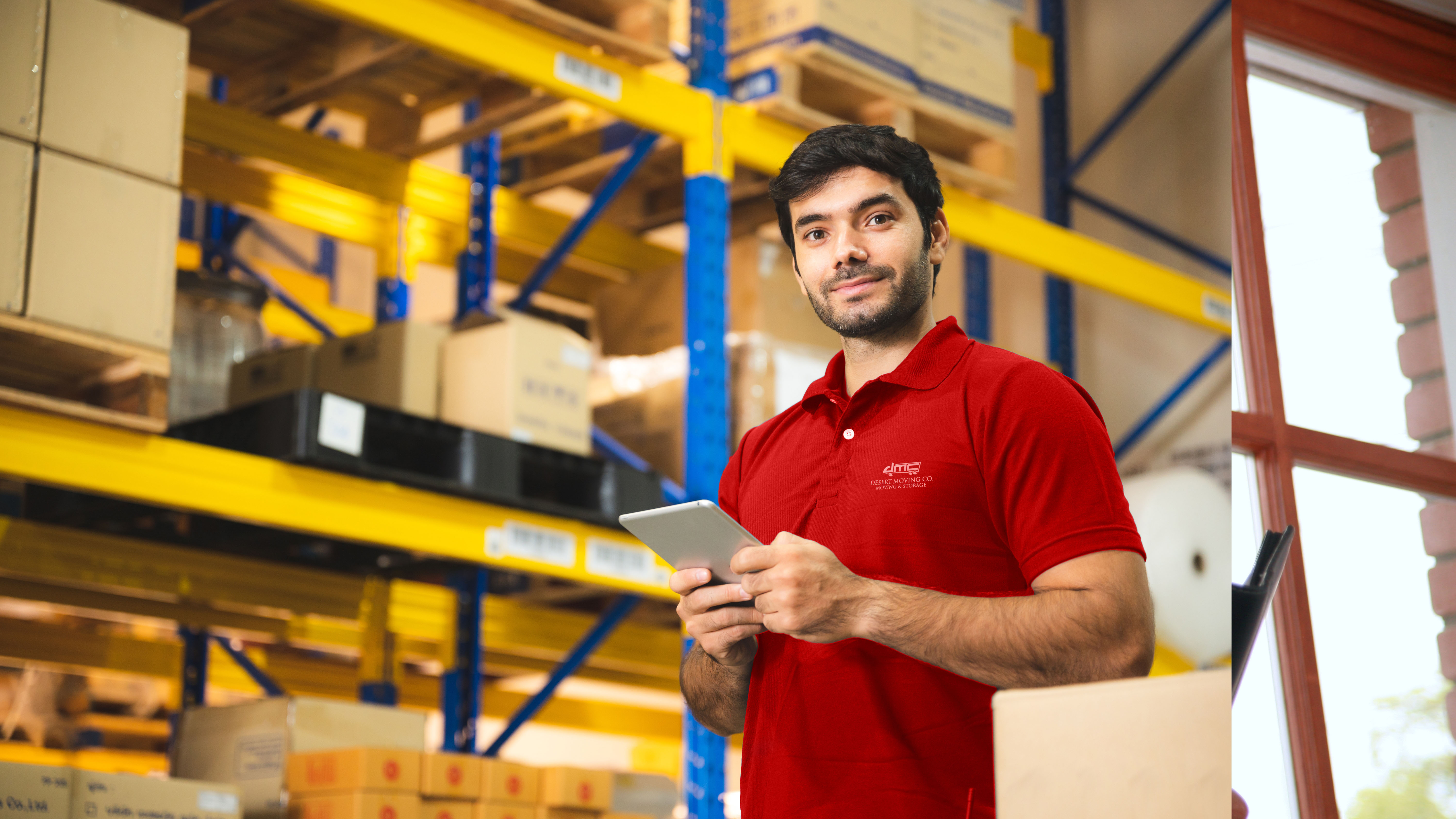 Desert Moving employee with tablet in storage facility